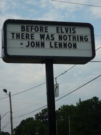 Picture of a sign across from Graceland that quotes John Lennon, who said, 